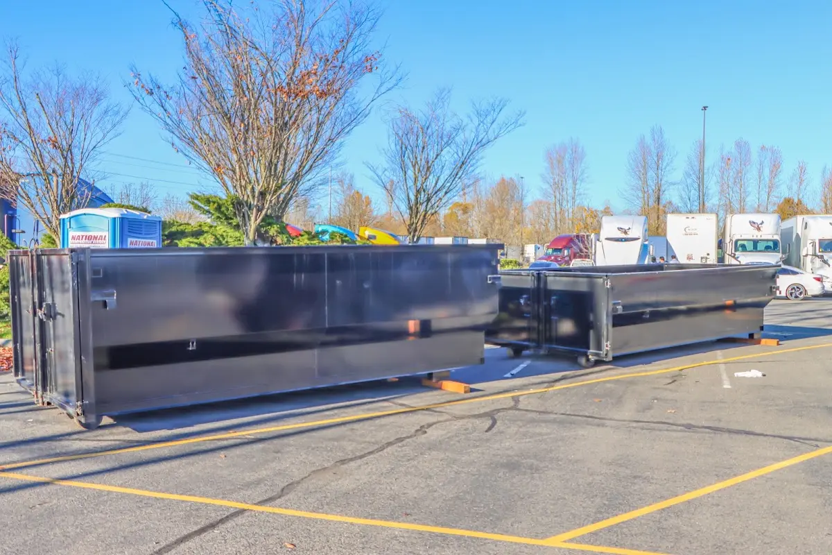 Professional dumpster rental service with roll-off container on residential driveway in Schererville